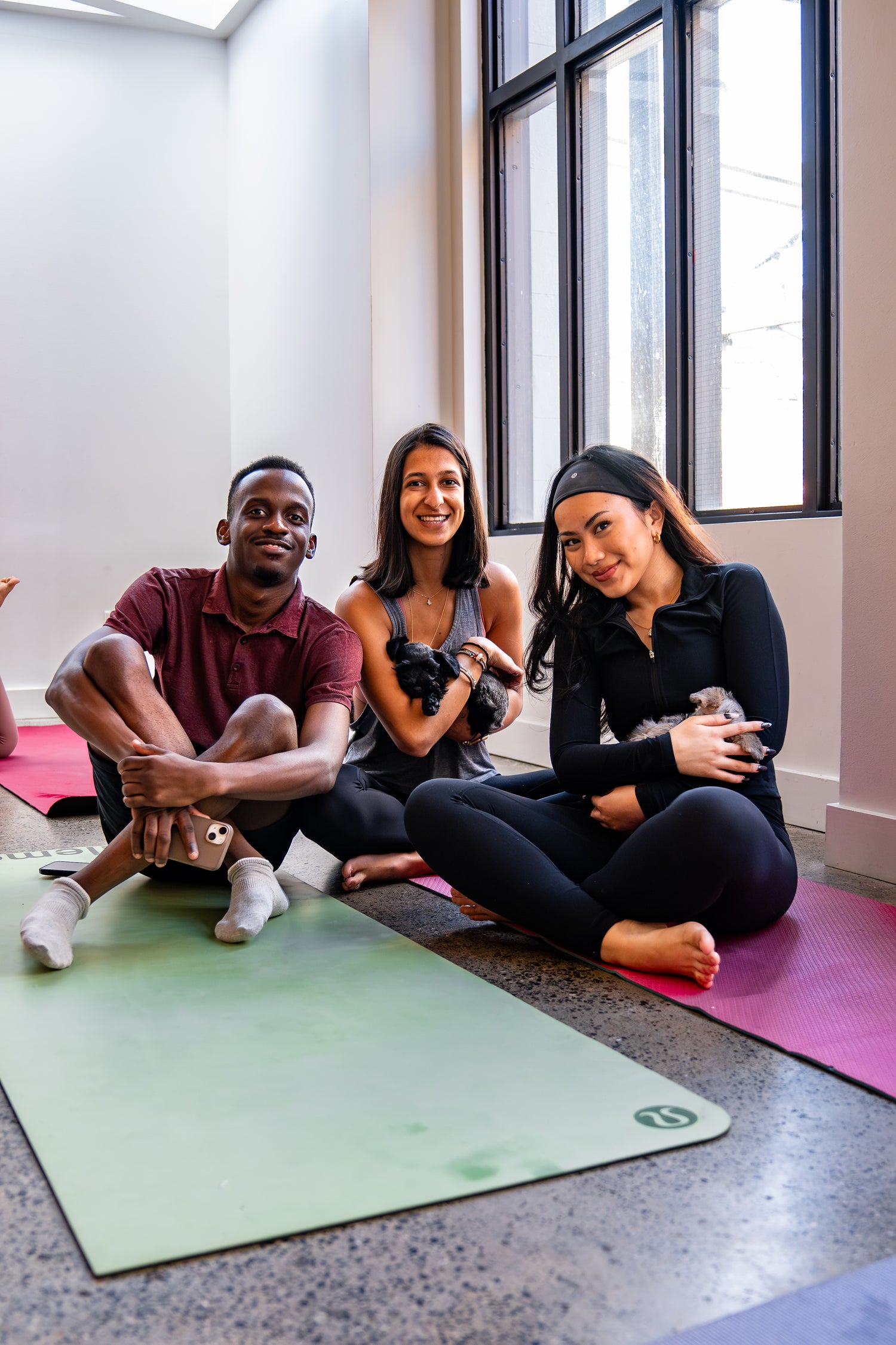 happy group of people of three women practicing yoga in the studio